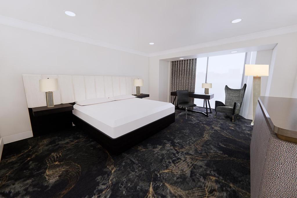 סוויטת המלון עם רצפת שטיח שחורה ומיטה לבנה